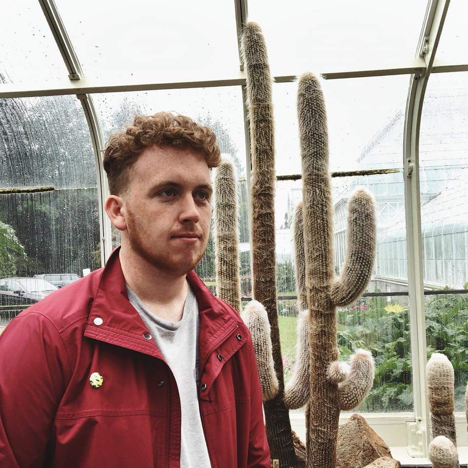 A photo of Dan McKeon, standing in front of a cactus in Portland, OR